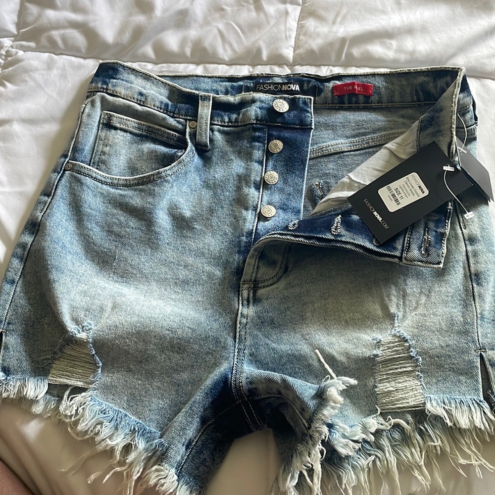 BRAND NEW. Never worn. Fashion Nova Denim shorts with side split hem.